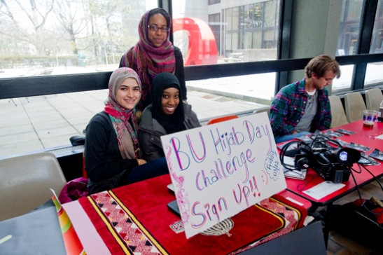 3/22/13 - Boston, MA Students wearing a  Hijab (head scarves)  during the BU Hijab Day Challenge sponsored by the Islamic Society of BU. Sarah Dolaty (CAS 14) and Asma Bashir (CAS 14) with Cheria Hunt (COM 14) (background) Photograph by Vernon Doucette for Boston University Photography